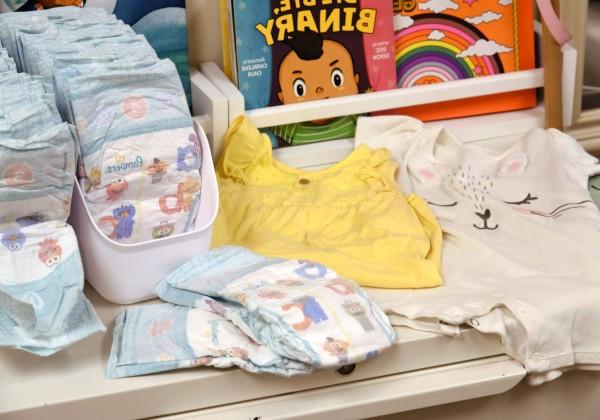 Disposable diapers, children's books on a table.