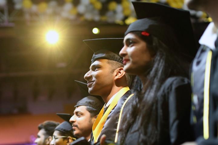 students at commencement in regalia 